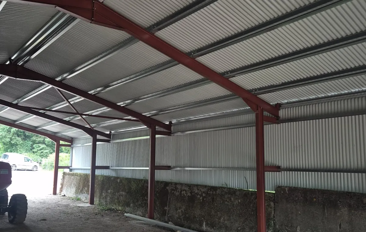 Inside a steel-framed shed: box profile roof and walls on a red steel frame